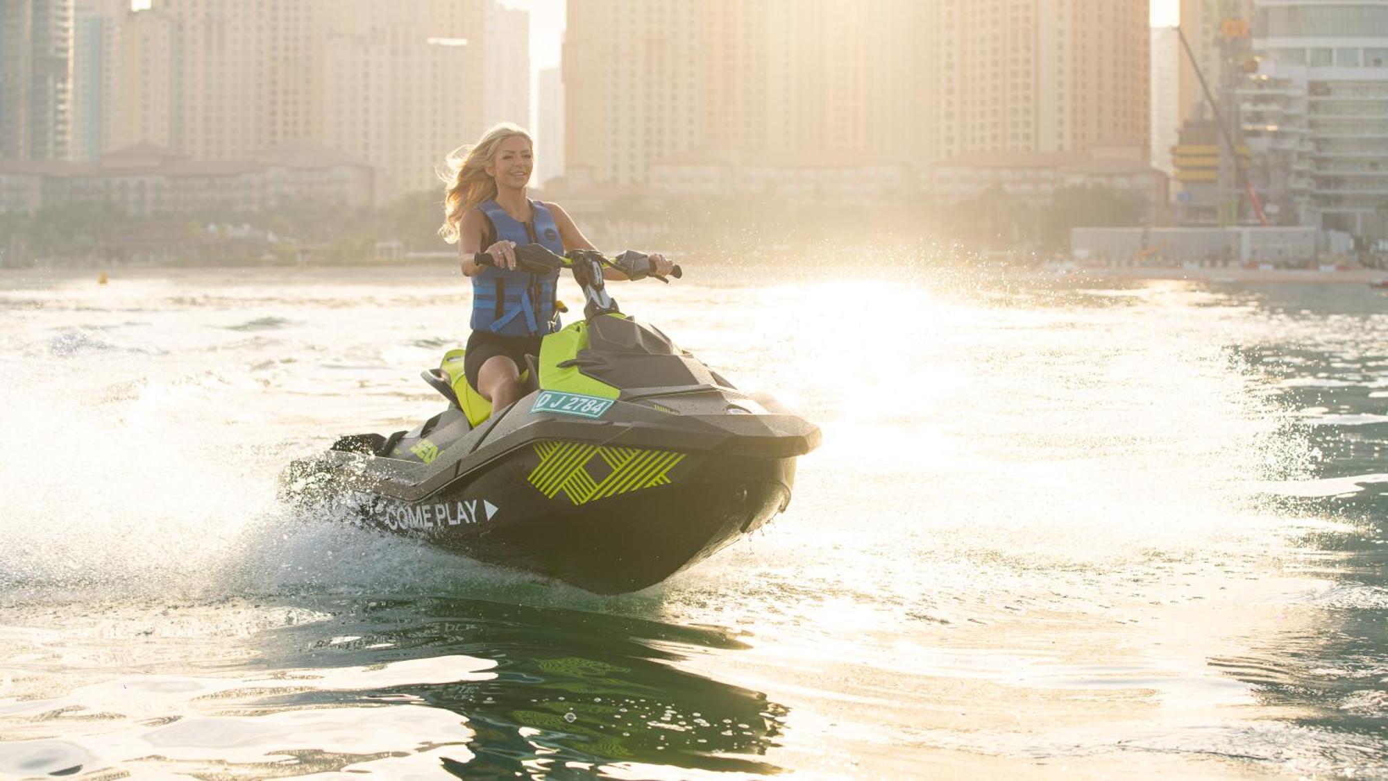 Hotel Five Luxe Dubai Esterno foto A woman riding a personal watercraft